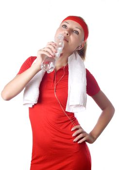 Sporty woman with water, towel and headphones on white