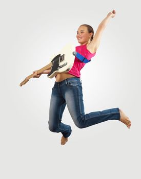 young woman playing on electro guitar and jumping