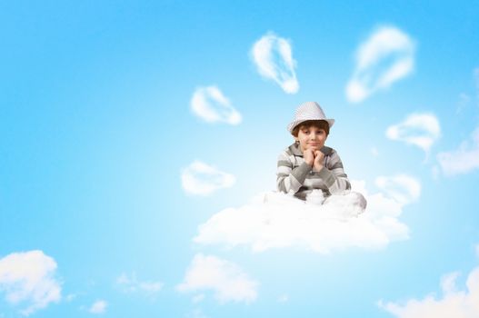 Image of little boy sitting on clouds and relaxing