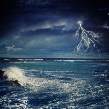 Image of night stormy sea with big waves and lightning