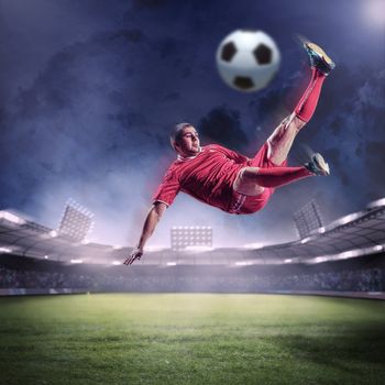 football player in red shirt striking the ball at the stadium