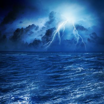 Image of night stormy sea with big waves and lightning