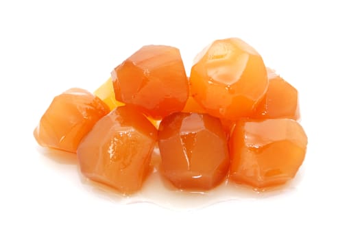 Pile of sticky stem ginger pieces, isolated on a white background