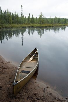 Lake and canoe before portage in rainy day in Algonquin Park