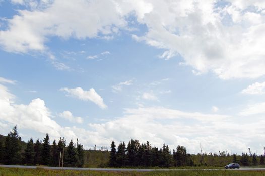 car on Canada Highway under cloud blue sky