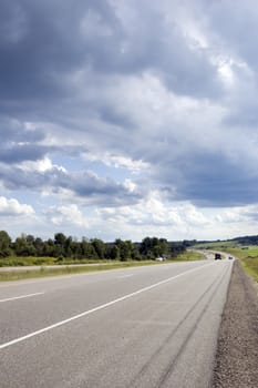 Highway through Muskoka country under cloudy sky