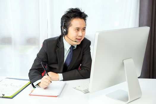 businessman making tele conference with desktop computer