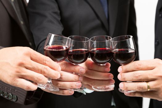 Close-up of human hands cheering up with flutes of wine