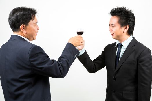 Two businessmen cheering up with flutes of wine