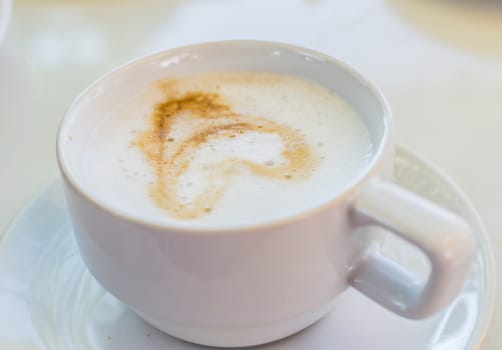 Hot Coffee in white cup and drink it in the morning with breakfast.