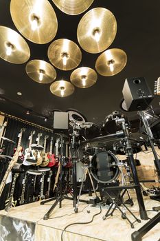 A vertical low angle shot of a drum set in a musical instrument store