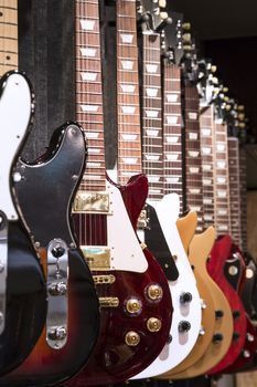 A vertical shot of a roll of Electric Guitars in display for sale.