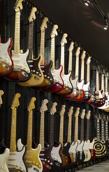 A wall of Electric Guitars in display for sale.