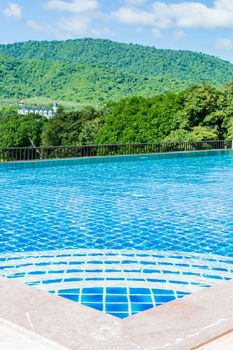 Pool blue color amid natural forest in Thailand.