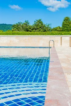 Pool blue color amid natural forest in Thailand.