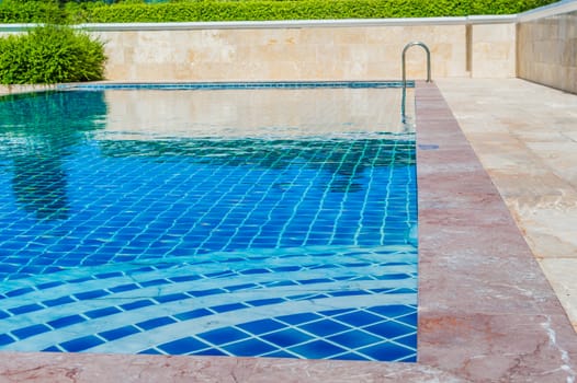 Pool blue color amid natural forest in Thailand.