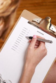 A young woman does an inventory check of the company supplies.