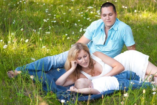 Young family recreate in park.