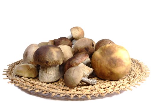 Strong white mushrooms in a wicker dish.. are Presented on a white background.