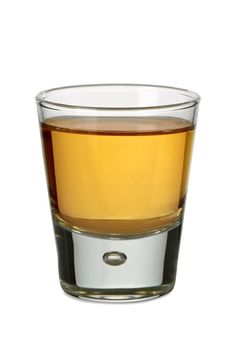 Photo of a shot glass filled with whiskey or bourbon.