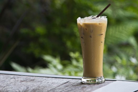 Ice coffee on a wooden table