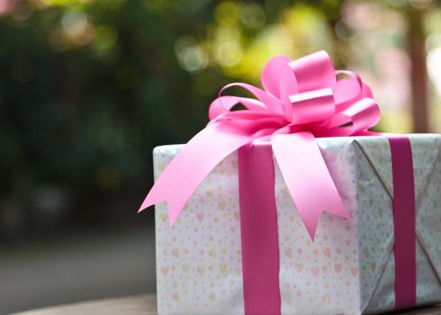 Images of pink gift boxes located on the table