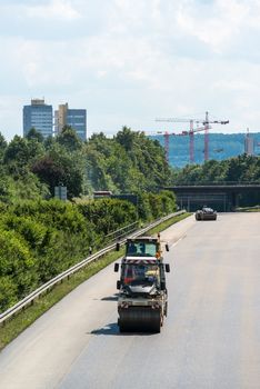 STUTTGART, GERMANY - AUGUST 10,2013: Workers laying asphalt on a public interstate (B27) during holiday season on August 10, 2013 in Stuttgart, Germany.