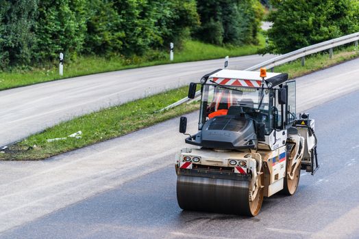 STUTTGART, GERMANY - AUGUST 10,2013: Workers laying asphalt on a public interstate (B27) during holiday season on August 10, 2013 in Stuttgart, Germany.