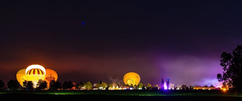 OSTFILDERN, GERMANY - AUGUST 17,2013: Flammende Sterne (flaming stars), the world fireworks championship is happening as a large festival accompanied by hot air balloons and tents on August 17, 2013 in Ostfildern near Stuttgart, Germany.