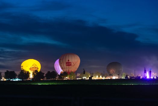 OSTFILDERN, GERMANY - AUGUST 17,2013: Flammende Sterne (flaming stars), the world fireworks championship is happening as a large festival accompanied by hot air balloons and tents on August 17, 2013 in Ostfildern near Stuttgart, Germany.