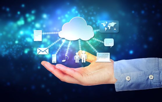 Cloud computing connectivity concept being held in a one persons hand on blue technology background