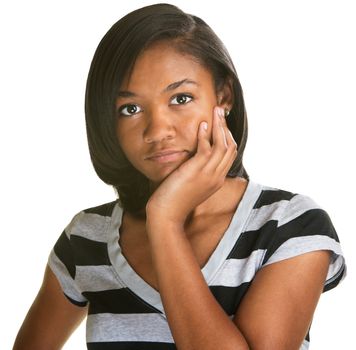 Pensive female teenager with chin in palm on isolated background