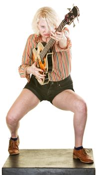 Frowning guitar player dancing and performing on white