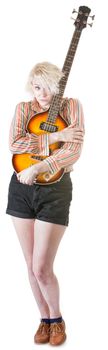 Timid young European female hugging a guitar