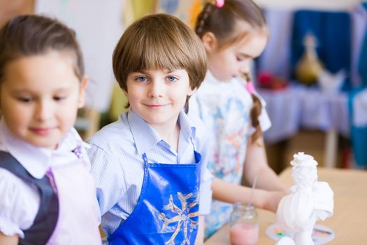 Little children painting and playing at kindergarten