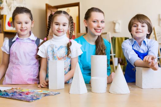 Little children painting and playing at kindergarten