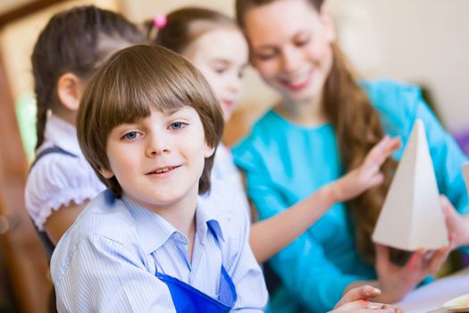 Little children painting and playing at kindergarten