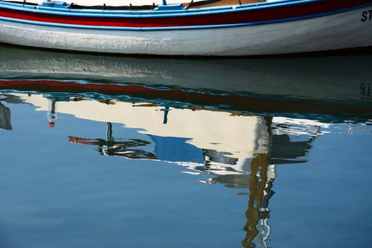 reflection of the old wooden fishing boat