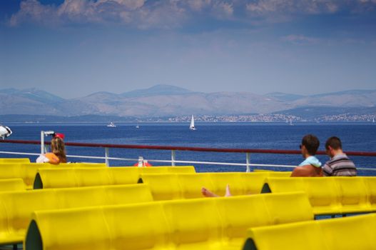 Blured people on boat sun deck, with nice background