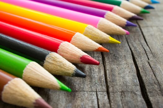 A Closeup of colorful  pencils on wood background