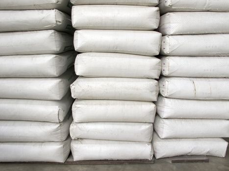 Pile of white plastic sacks in warehouse