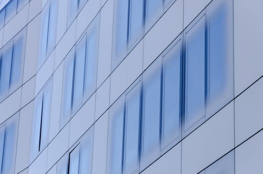 blue glass surface of a business building in the city