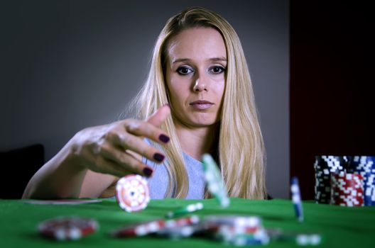 woman throwing poker chips on the table betting