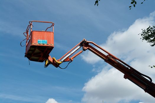  Crane with hydraulic boom lifted up sky background                              