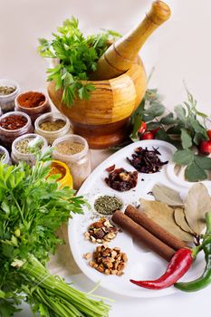 Mix of fresh herbs, spices and oil on the table