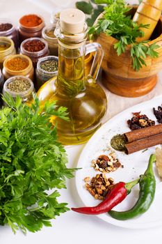 Mix of fresh herbs, spices and oil on the table