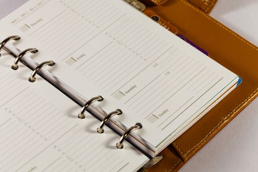 Close up image of black note book organizer against white background