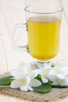 glass of jasmine tea and jasmine flowers