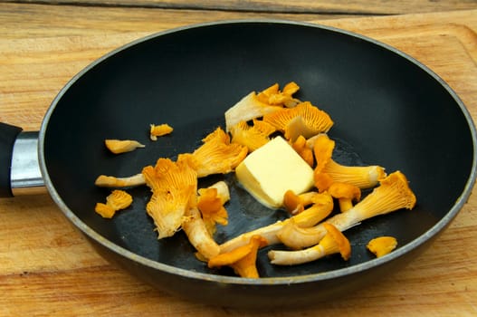 Fresh chanterelles in a frying pan with butter