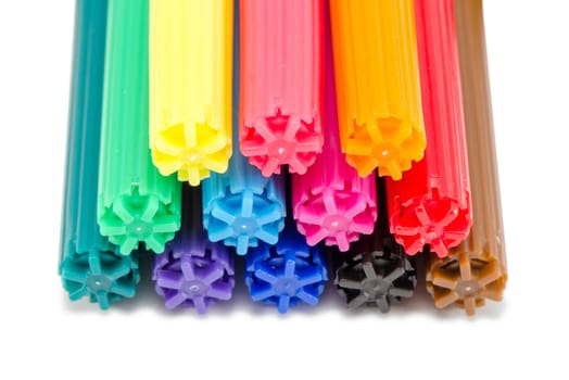 closeup of various color stacked felt tip pens isolated on white background.